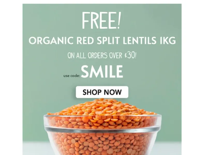 A glass bowl filled with organic red split lentils; a free 1kg bag is offered with orders over £30 using code SMILE.