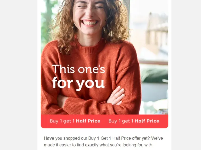 Smiling woman with arms crossed, wearing an orange sweater.  Buy 1 get 1 half price offer on beauty products.